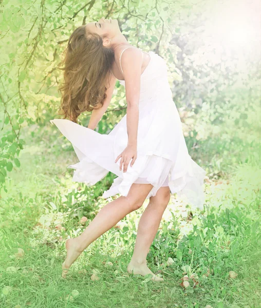 Woman dancing in the orchard — Stock Photo, Image