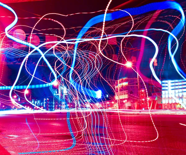 Colorful ribbons over night streets — Stock Photo, Image