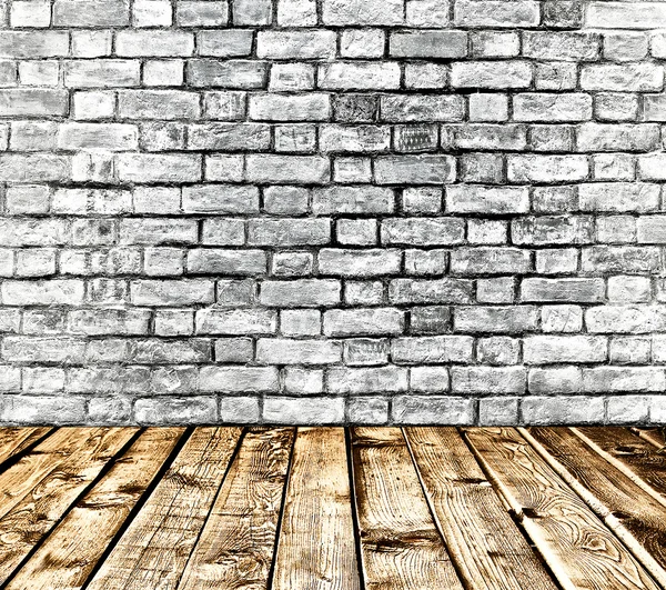 Empty old spacious room with stone grungy wall and wooden weathered dirty floor, vintage background texture of brickwall