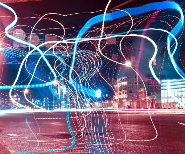 Colorful ribbons over night streets — Stock Photo, Image