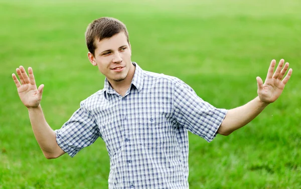 Active smiling young man enjoying in nature — Stock Photo, Image