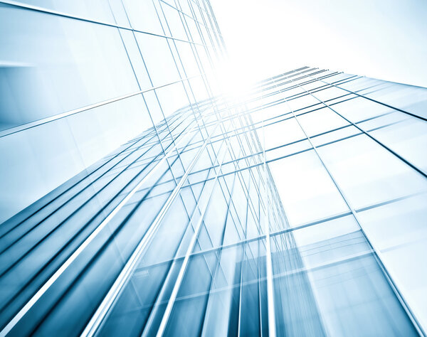 Panoramic and perspective wide angle view to steel blue background of glass high rise building skyscrapers in modern futuristic downtown at night Business concept of successful industrial architecture
