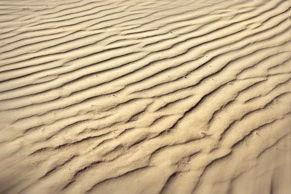 Verwirrte Textur des Sandstrandes — Stockfoto