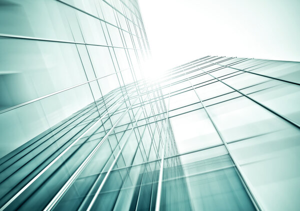 Panoramic and perspective wide angle view to steel blue background of glass high rise building skyscrapers in modern futuristic downtown at night Business concept of successful industrial architecture