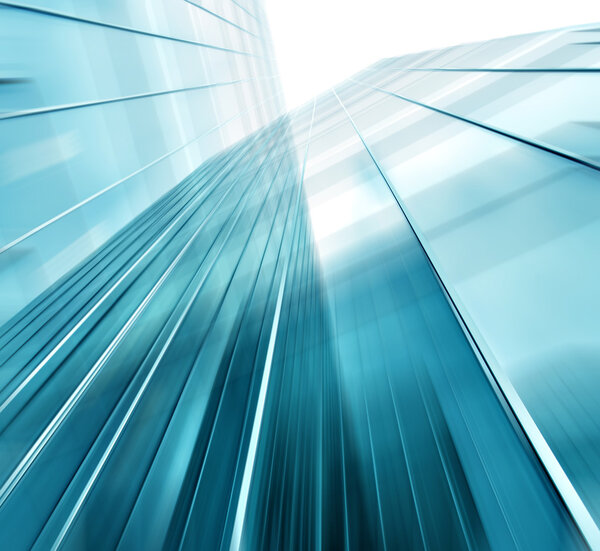 Panoramic and prospective wide angle view to steel light blue background of glass high rise building skyscraper commercial modern city of future. Business concept of successful industrial architecture