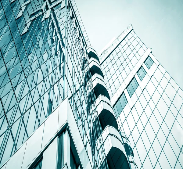 Panoramic and prospective wide angle view to steel light blue background of glass high rise building skyscraper commercial modern city of future. Business concept of successful industrial architecture — Stock Photo, Image