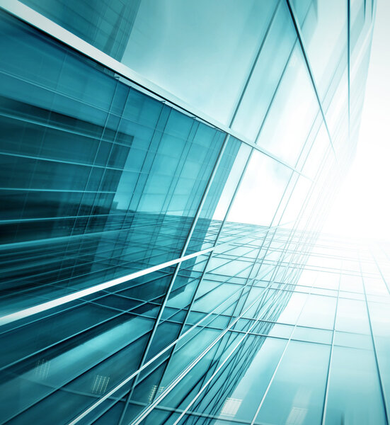 Panoramic and prospective wide angle view to steel light blue background of glass high rise building skyscraper commercial modern city of future. Business concept of successful industrial architecture