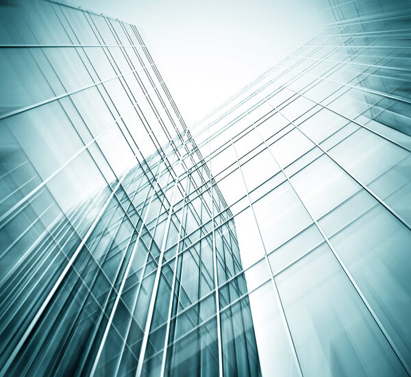 Panoramic and prospective wide angle view to steel light blue background of glass high rise building skyscraper commercial modern city of future. Business concept of successful industrial architecture