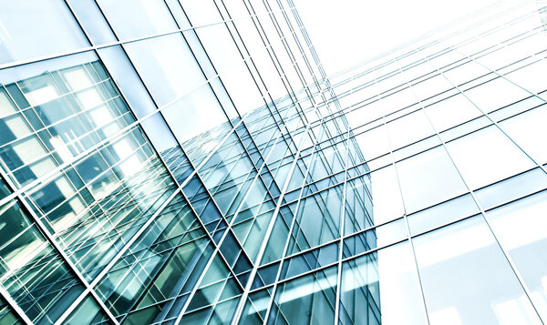 Panoramic and prospective wide angle view to steel light blue background of glass high rise building skyscraper commercial modern city of future. Business concept of successful industrial architecture