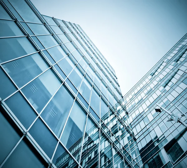 Panoramic and prospective wide angle view to steel light blue background of glass high rise building skyscraper commercial modern city of future. Business concept of successful industrial architecture — Stock Photo, Image