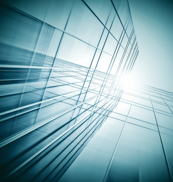 Panoramic and prospective wide angle view to steel light blue background of glass high rise building skyscraper commercial modern city of future. Business concept of successful industrial architecture