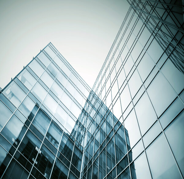 Panoramic and prospective wide angle view to steel light blue background of glass high rise building skyscraper commercial modern city of future. Business concept of successful industrial architecture