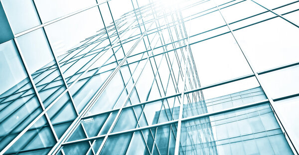 Panoramic and prospective wide angle view to steel light blue background of glass high rise building skyscraper commercial modern city of future. Business concept of successful industrial architecture