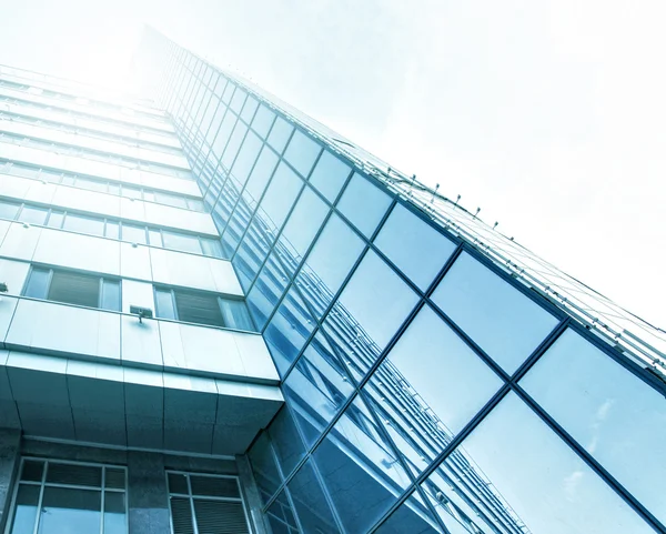 Panoramic and prospective wide angle view to steel light blue background of glass high rise building skyscraper commercial modern city of future. Business concept of successful industrial architecture — Stock Photo, Image