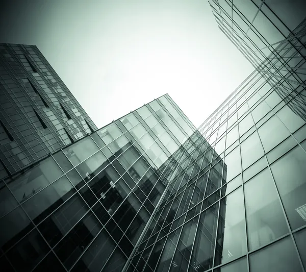 Panoramic and prospective wide angle view to steel light blue background of glass high rise building skyscraper commercial modern city of future. Business concept of successful industrial architecture — Stock Photo, Image