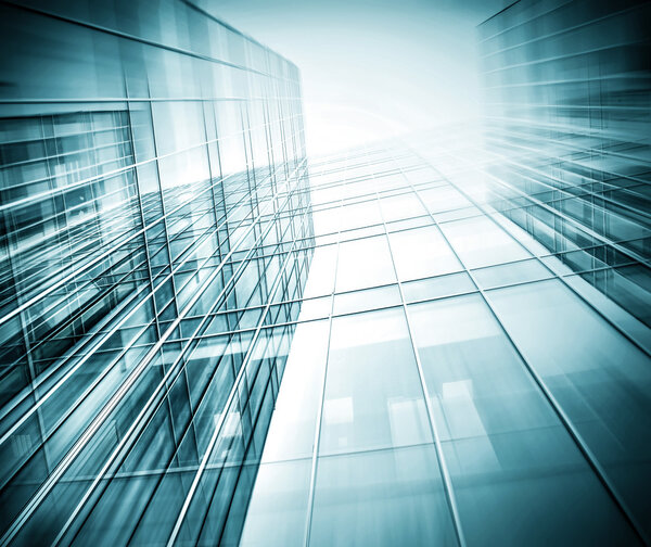 Panoramic and prospective wide angle view to steel light blue background of glass high rise building skyscraper commercial modern city of future. Business concept of successful industrial architecture