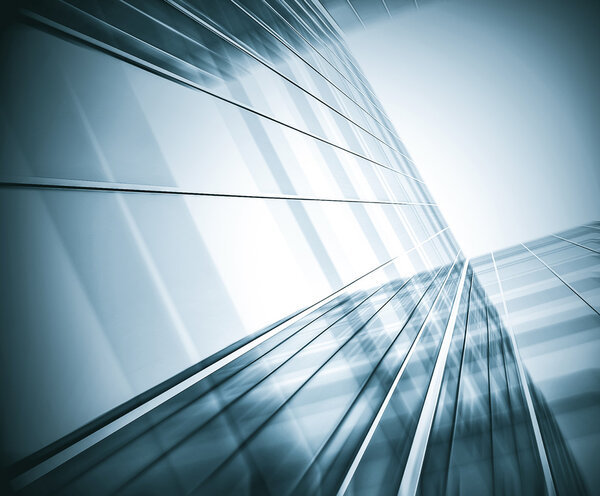 Panoramic and prospective wide angle view to steel light blue background of glass high rise building skyscraper commercial modern city of future. Business concept of successful industrial architecture