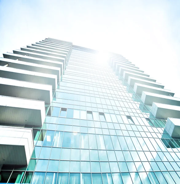 Panoramic and prospective wide angle view to steel light blue background of glass high rise building skyscraper commercial modern city of future. Business concept of successful industrial architecture — Stock Photo, Image