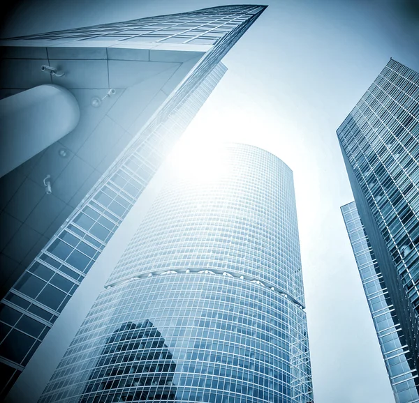 Panoramic and prospective wide angle view to steel light blue background of glass high rise building skyscraper commercial modern city of future. Business concept of successful industrial architecture — Stock Photo, Image