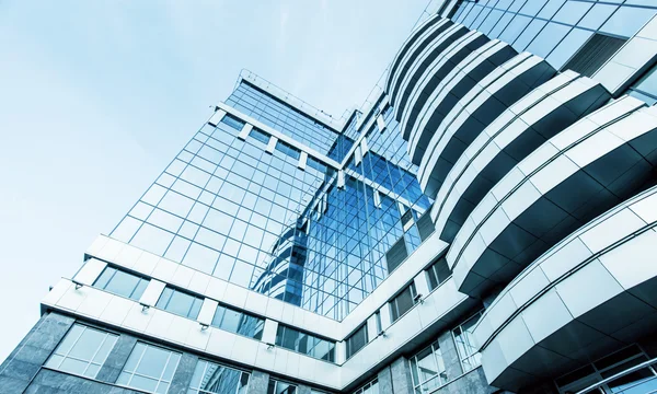 Panoramic and prospective wide angle view to steel light blue background of glass high rise building skyscraper commercial modern city of future. Business concept of successful industrial architecture — Stock Photo, Image