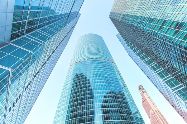 Panoramic and prospective wide angle view to steel light blue background of glass high rise building skyscraper commercial modern city of future. Business concept of successful industrial architecture — Stock Photo, Image