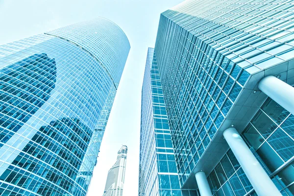 Panoramic and prospective wide angle view to steel light blue background of glass high rise building skyscraper commercial modern city of future. Business concept of successful industrial architecture — Stock Photo, Image