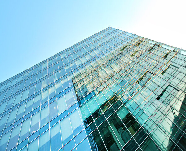 Panoramic and prospective wide angle view to steel light blue background of glass high rise building skyscraper commercial modern city of future. Business concept of successful industrial architecture