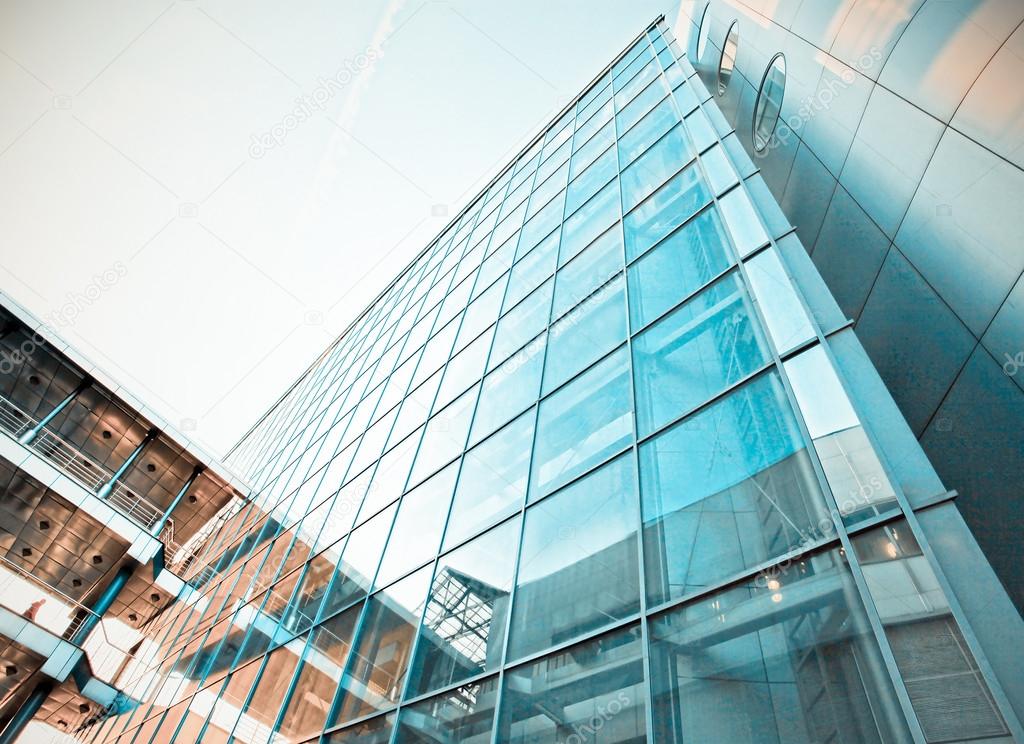 Panoramic and prospective wide angle view to steel light blue background of glass high rise building skyscraper commercial modern city of future. Business concept of successful industrial architecture