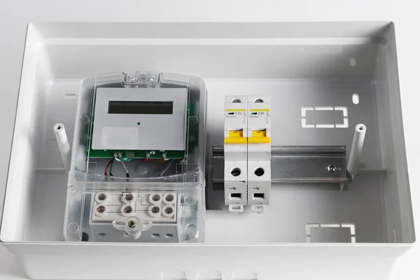 Electricity meter in a plastic electrical panel.