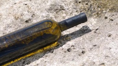 Bottle of wine on the rocky seashore. Caspian Sea. 07 June 2022 Year.