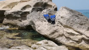 Flippers on the rocky seashore. Caspian Sea. 07 June 2022 Year.