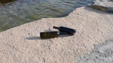 Two bottles of wine by the sea. Caspian Sea. 07 June 2022 Year.