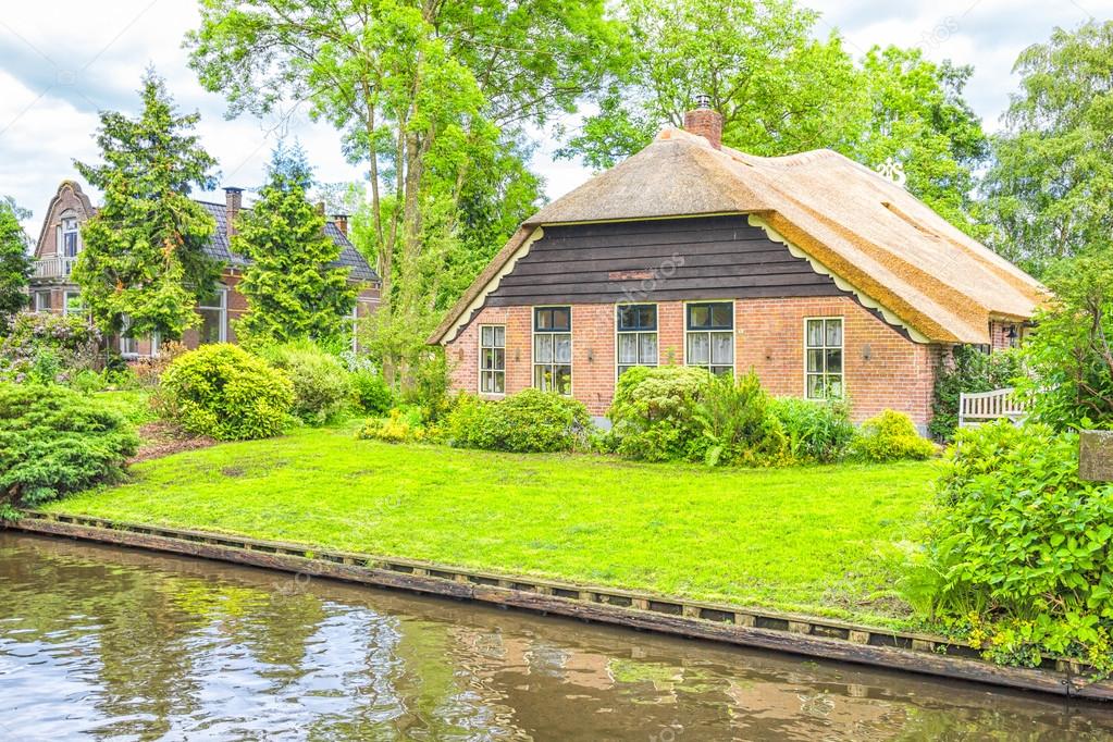 Typical Dutch houses and gardens in Giethoorn, The Netherlands Stock