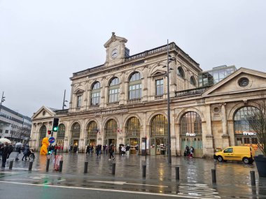 Lille, France - 27 December, 2022: People walking in front of the Lille Flandres train station. It's the main railway station of the city.