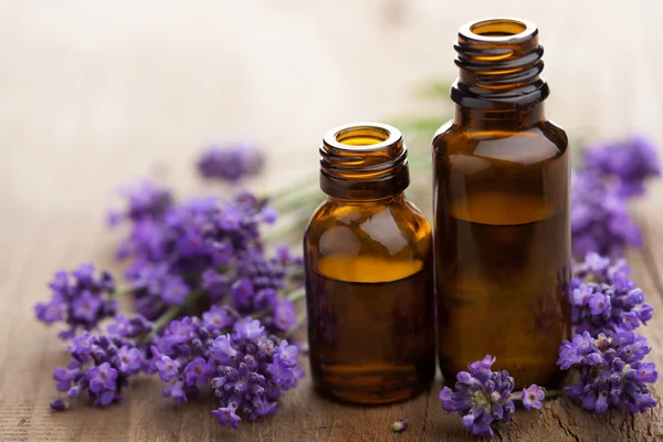 Essential oil and lavender flowers — Stock Photo, Image