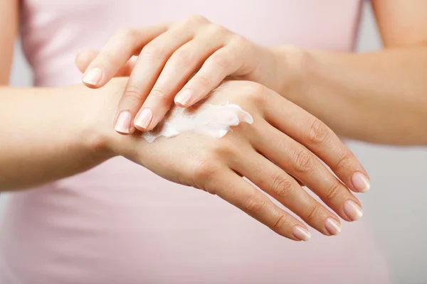 Beautiful woman hands with cream — Stock Photo, Image