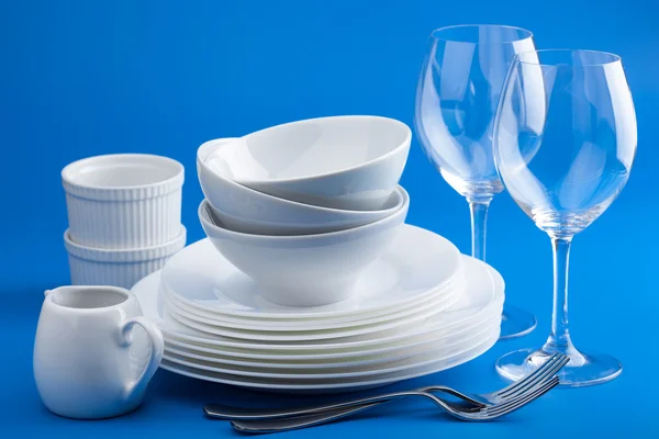 white tableware over blue background