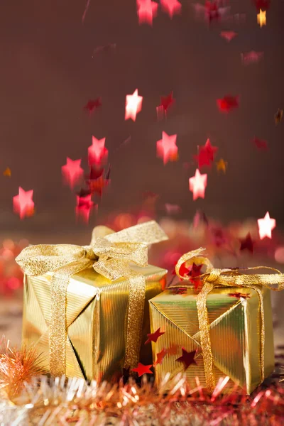 Stars falling over christmas gifts — Stock Photo, Image