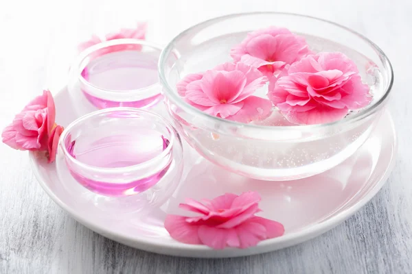 Spa set with begonia flowers and essential oil — Stock Photo, Image