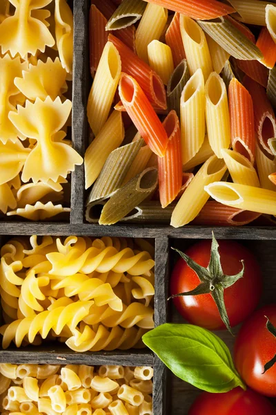 Various pasta in black wooden box — Stock Photo, Image