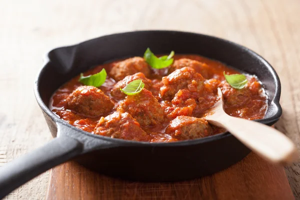 Meatballs with tomato sauce in black pan — Stock Photo, Image