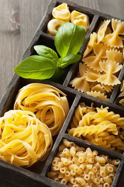 Various pasta in black wooden box — Stock Photo, Image