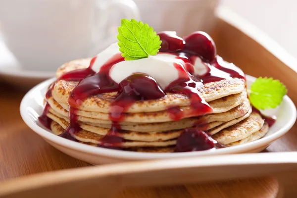 Pancakes with cherry jam and cream for breakfast — Stock Photo, Image