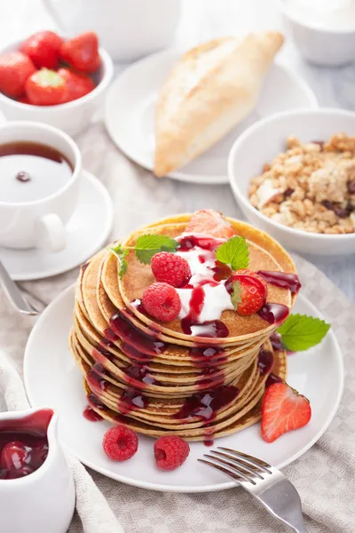 Pancakes with berry and jam for breakfast — Stock Photo, Image