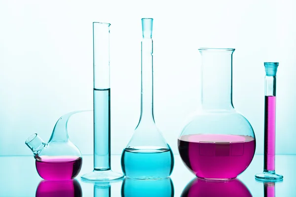 Laboratory glassware with colorful chemicals — Stock Photo, Image