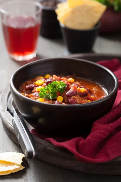 Mexican chili con carne in black bowl with tortilla — Stock Photo, Image