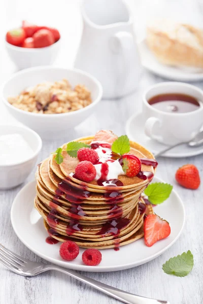 Pancakes with berry and jam for breakfast — Stock Photo, Image