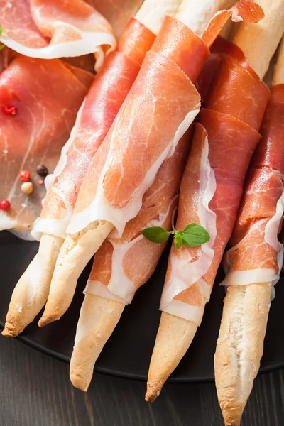 Prosciutto ham and grissini bread sticks — Stock Photo, Image