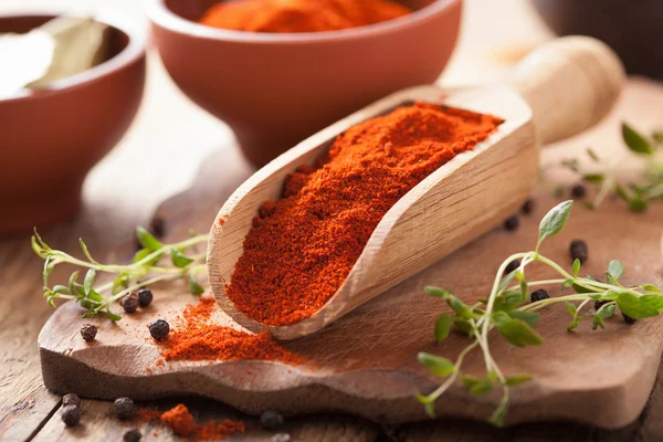 Red ground paprika spice in wooden scoop and bowl — Stock Photo, Image