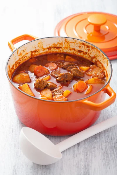 Beef stew with potato and carrot in red casserole — Stock Photo, Image